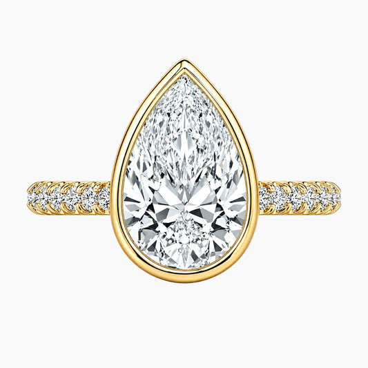 Yellow gold ring with pear-shaped moissanite center stone and pavé band