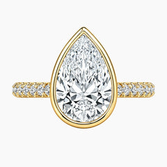 Yellow gold ring with pear-shaped moissanite center stone and pavé band