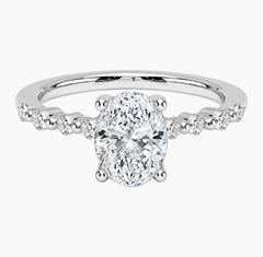 Oval-cut moissanite ring featuring an 18K white gold-plated band set with pavé diamonds; an elegant solitaire-style engagement ring.
