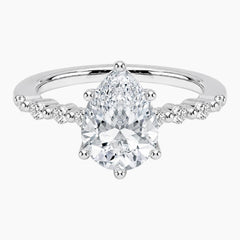Pear-cut moissanite ring featuring an 18K white gold-plated band set with pavé diamonds; an elegant solitaire-style engagement ring.