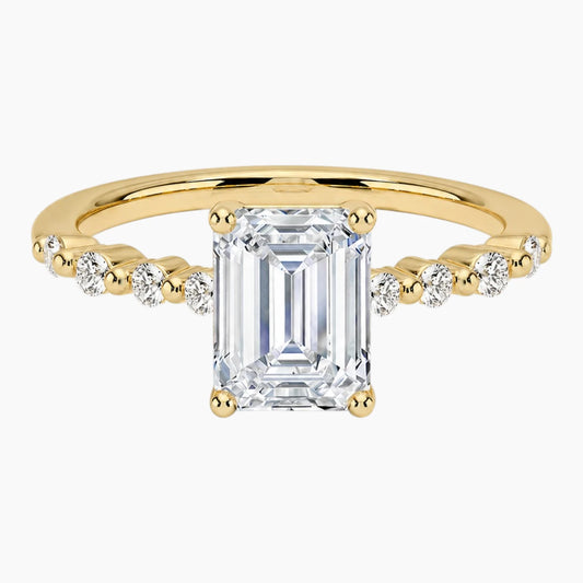 Emerald-cut moissanite ring featuring an 18K white gold-plated band set with pavé diamonds; an elegant solitaire-style engagement ring.