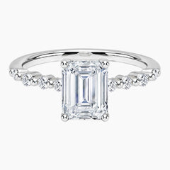 Emerald-cut moissanite ring featuring an 18K white gold-plated band set with pavé diamonds; an elegant solitaire-style engagement ring.