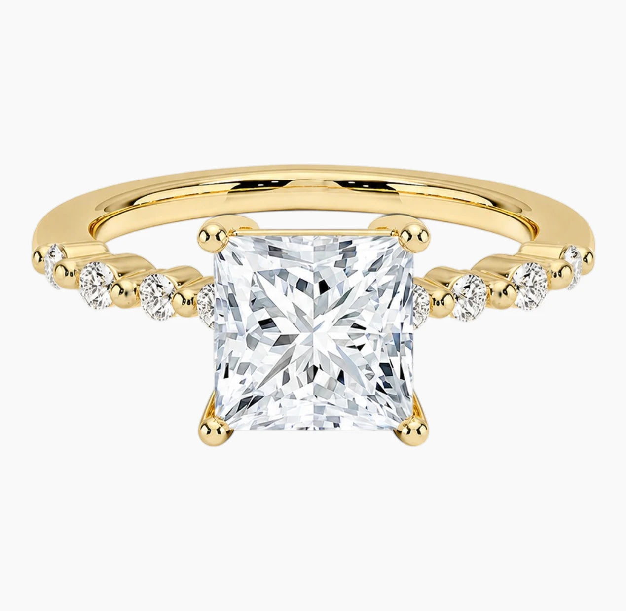 Princessl-cut moissanite ring featuring an 18K white gold-plated band set with pavé diamonds; an elegant solitaire-style engagement ring.