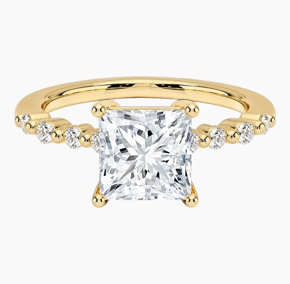 Princessl-cut moissanite ring featuring an 18K white gold-plated band set with pavé diamonds; an elegant solitaire-style engagement ring.