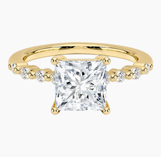 Princessl-cut moissanite ring featuring an 18K white gold-plated band set with pavé diamonds; an elegant solitaire-style engagement ring.