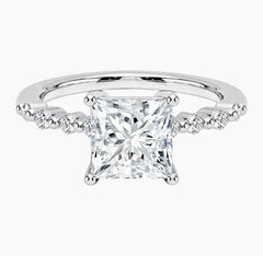 Princessl-cut moissanite ring featuring an 18K white gold-plated band set with pavé diamonds; an elegant solitaire-style engagement ring.