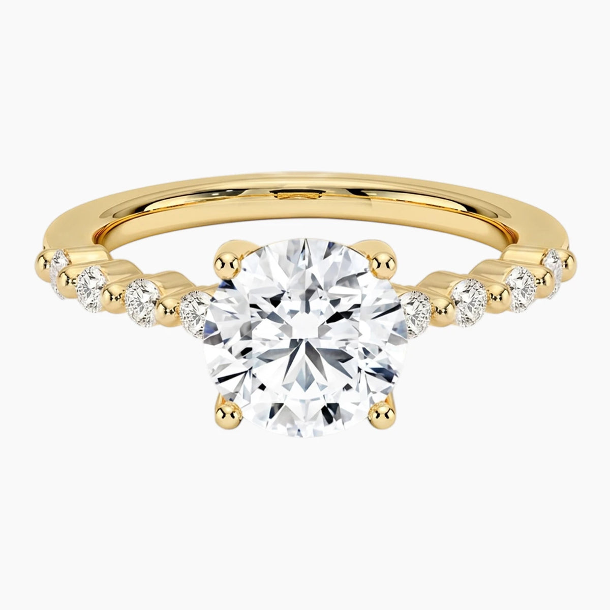 Round-cut moissanite ring featuring an 18K white gold-plated band set with pavé diamonds; an elegant solitaire-style engagement ring.