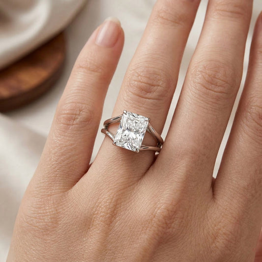 Radiant cut moissanite solitaire ring in silver setting on hand, elegant jewelry closeup