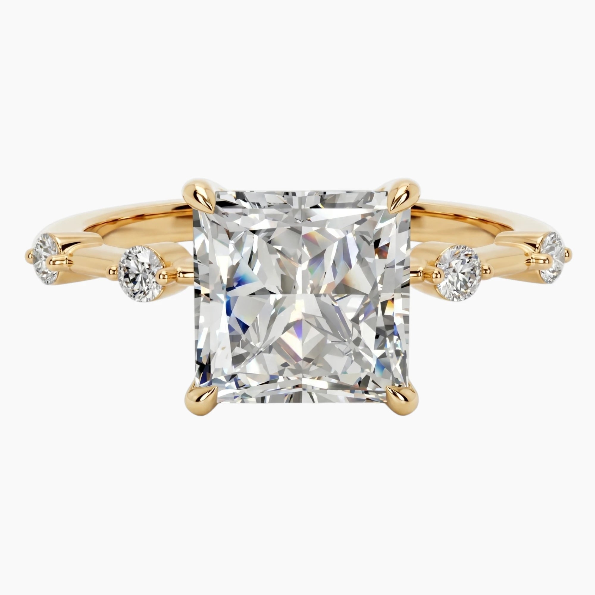 Gold ring with large square moissanite center stone and two small side stones