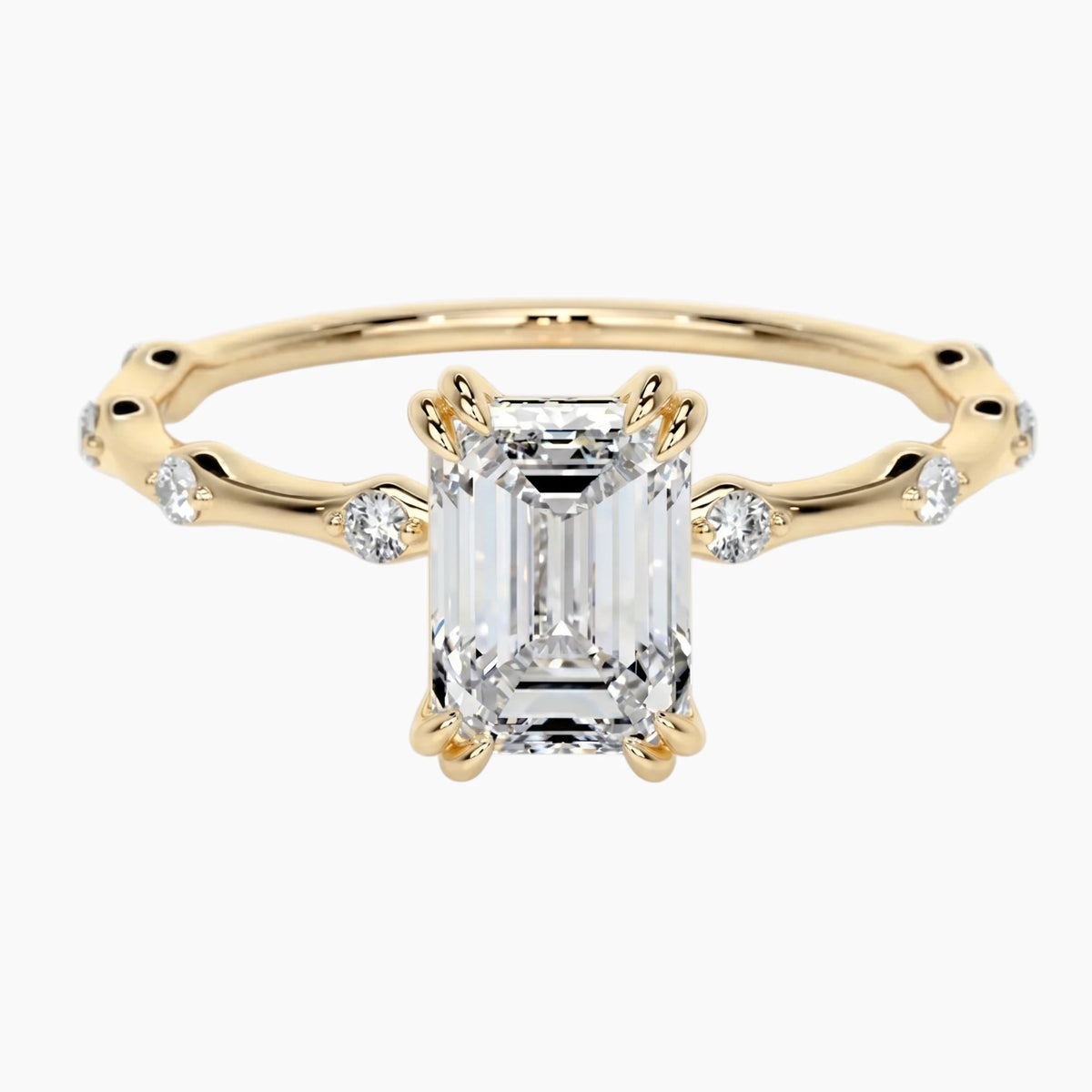 Yellow gold moissanite engagement ring with side accent stones on white background