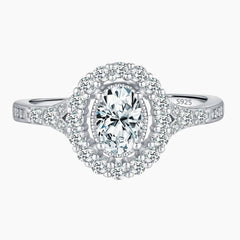Oval cut moissanite halo engagement ring in sterling silver with pavé band