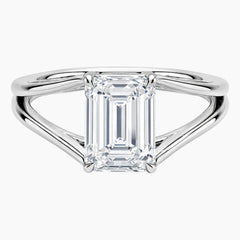 Emerald cut moissanite solitaire engagement ring with split shank in white metal