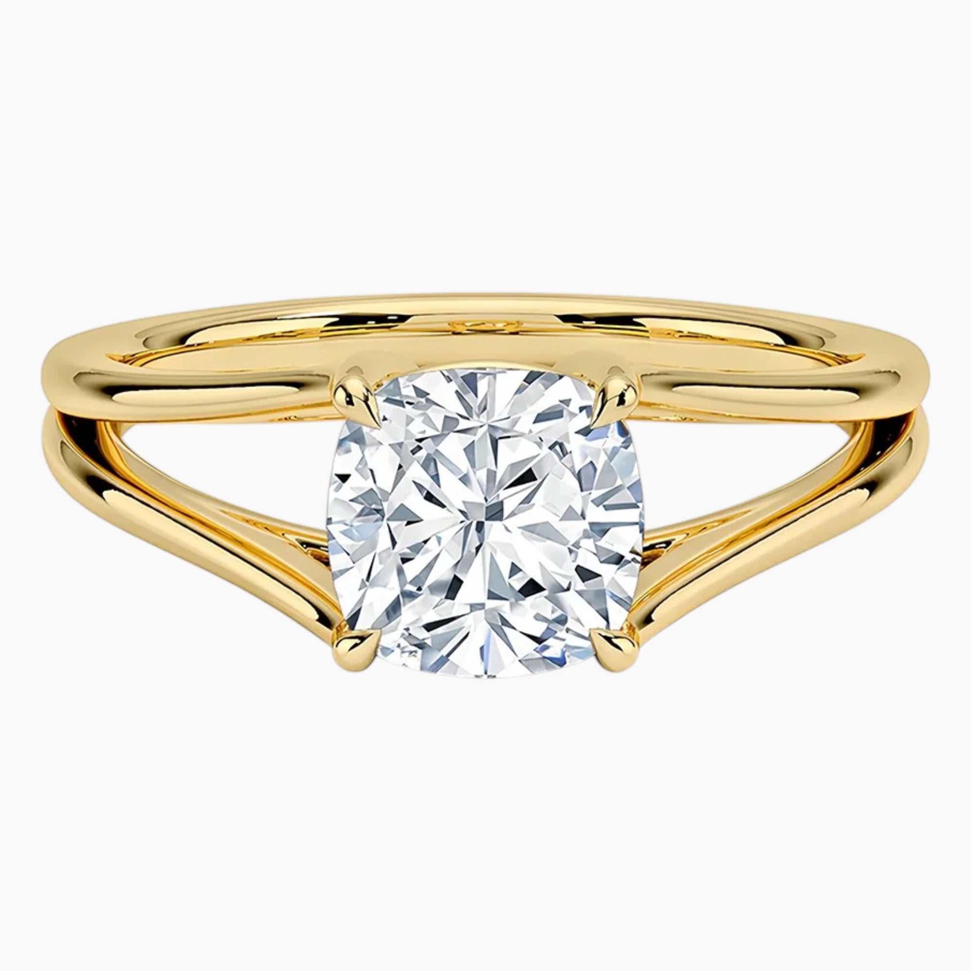 Gold split shank ring with round brilliant moissanite center stone on white background