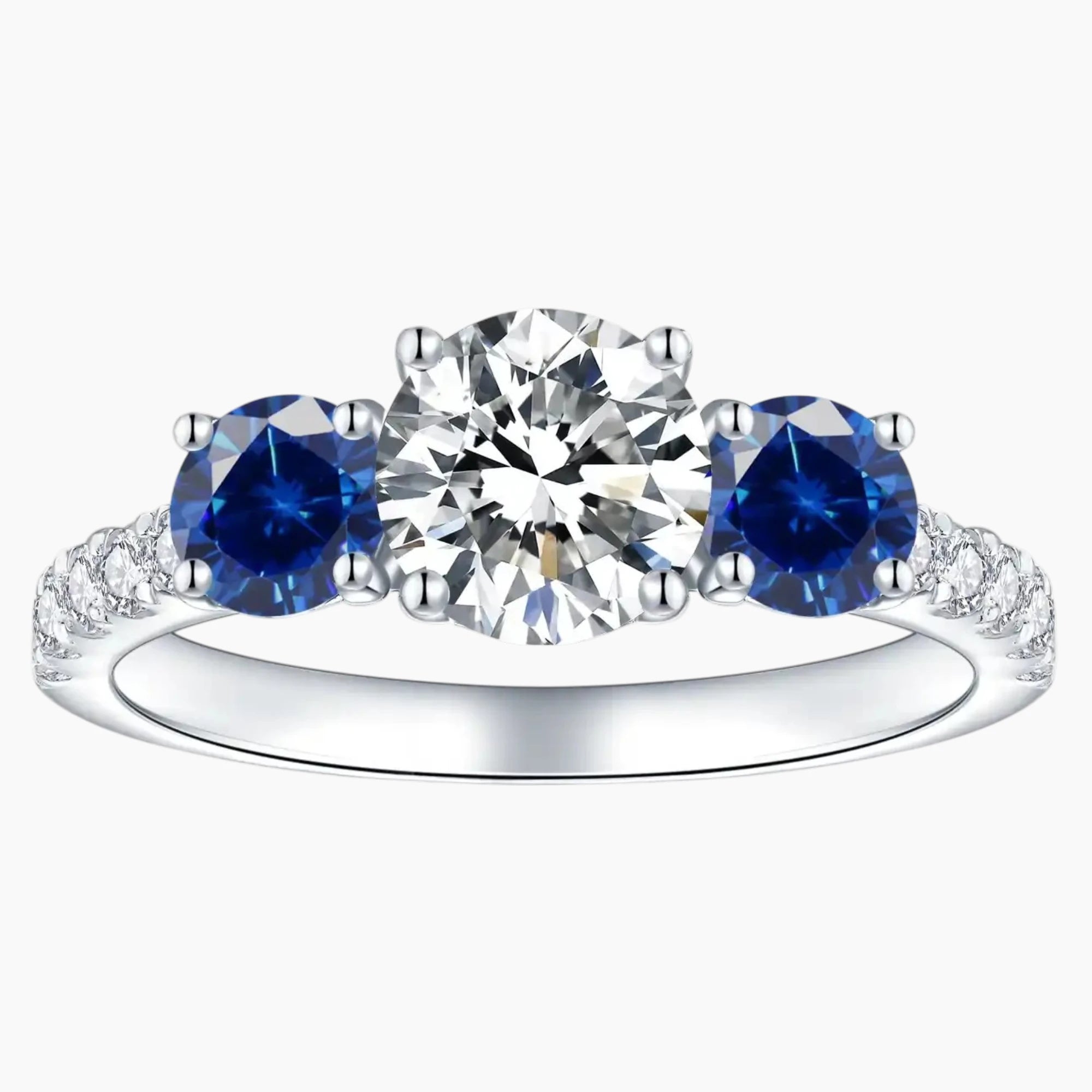Three stone moissanite and blue sapphire engagement ring in white gold setting