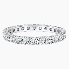 Sterling silver eternity band set with round moissanite stones, elegant fine jewelry