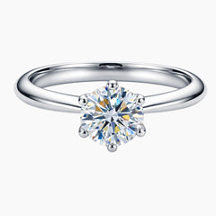 Round cut moissanite solitaire engagement ring on a silver band with six prongs