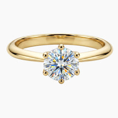 Round cut moissanite solitaire engagement ring on a Gold band with six prongs
