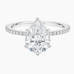 Pear-shaped moissanite engagement ring with pavé band in white gold setting
