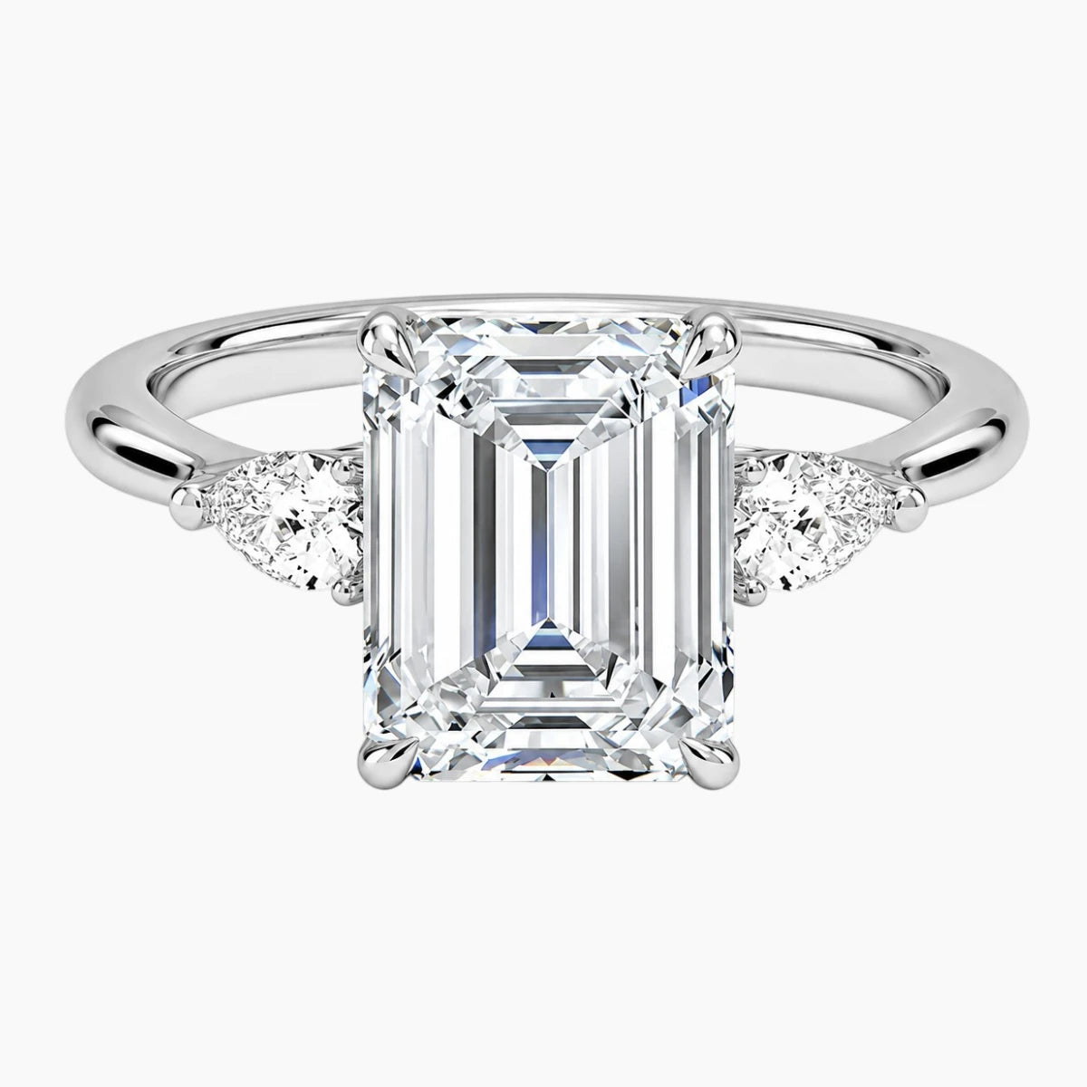 Emerald cut moissanite ring with side stones on silver gold band, luxury jewelry