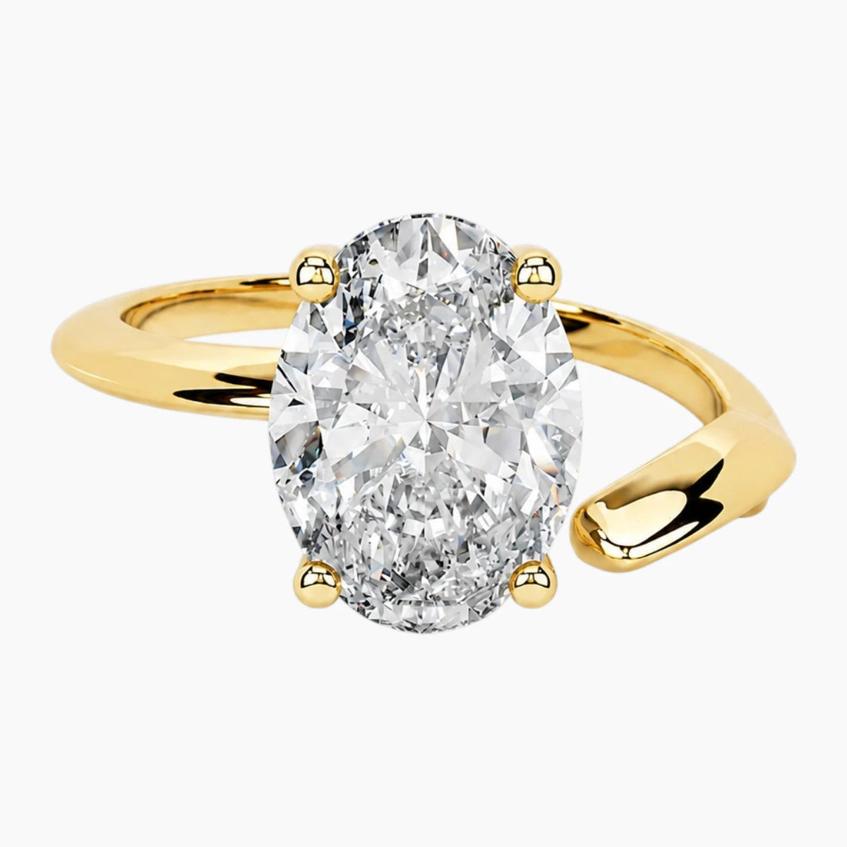 Oval moissanite solitaire ring with gold band on white background, ethical jewelry
