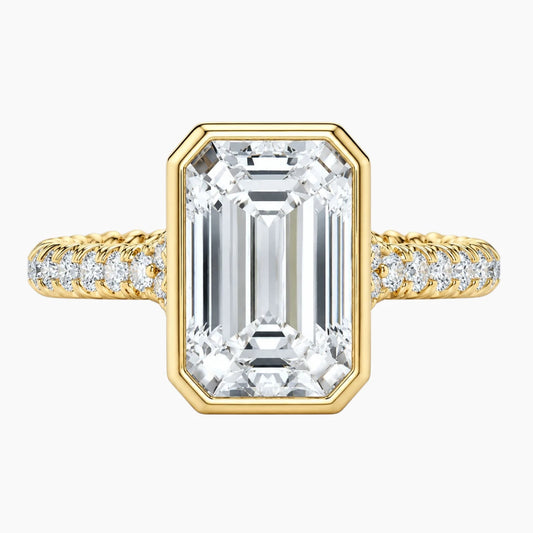 Emerald cut moissanite ring with gold band and pavé setting
