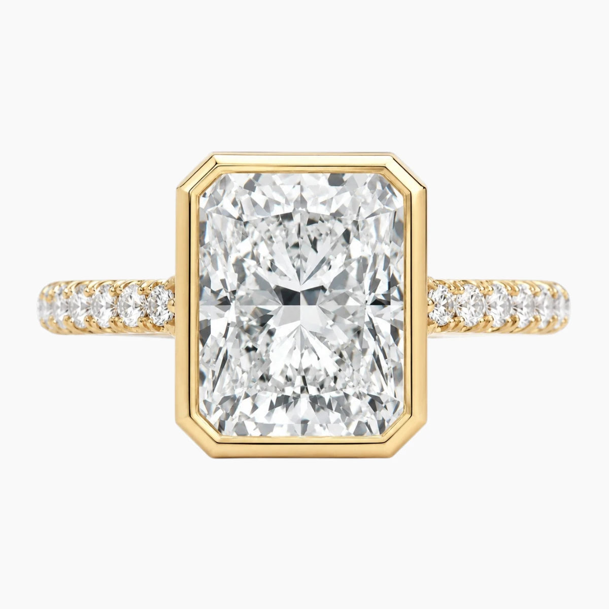 Radiant cut moissanite engagement ring with gold band and pavé side stones