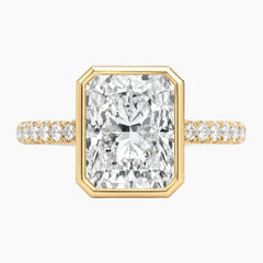 Radiant cut moissanite engagement ring with gold band and pavé side stones