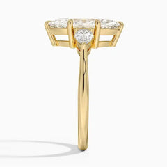 Side view of a gold ring with a large moissanite center stone and two accent stones