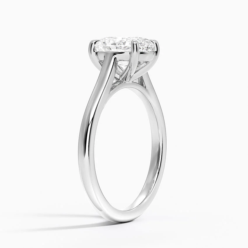 Solitaire moissanite engagement ring with round brilliant stone in a prong setting on white gold band