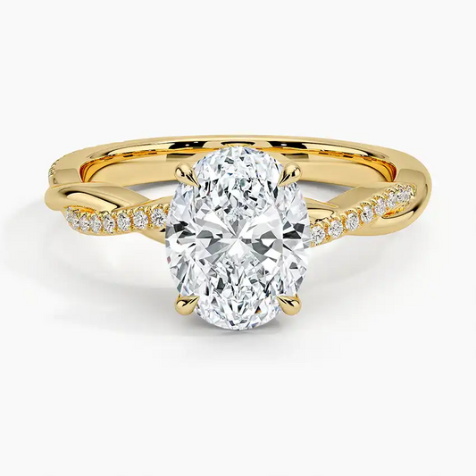 Oval moissanite engagement ring in yellow gold with twisted diamond band