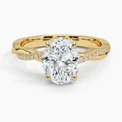 Oval moissanite engagement ring in yellow gold with twisted diamond band