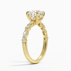 Gold moissanite engagement ring with a large round center stone and side accents