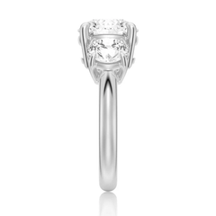 Side view of a silver moissanite engagement ring with round brilliant stones