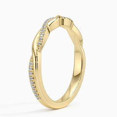Gold band ring with pavé moissanite stones in a twisted design on white background