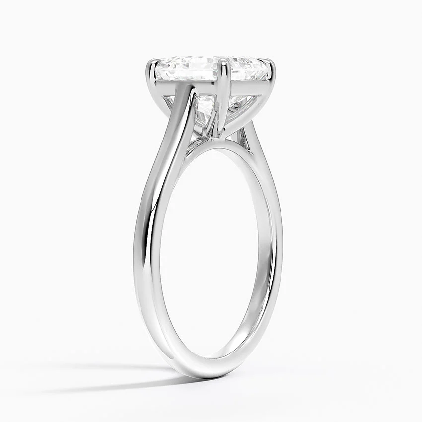 Solitaire moissanite engagement ring with a round brilliant stone on a white gold band