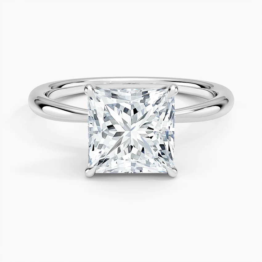 Princess cut moissanite engagement ring on a sleek silver band, solitaire setting