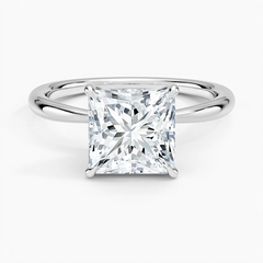 Princess cut moissanite engagement ring on a sleek silver band, solitaire setting