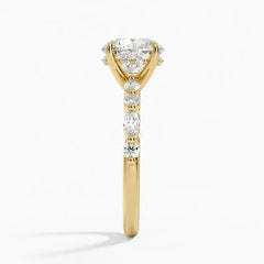 Gold moissanite engagement ring with round and marquise stones on band, side view