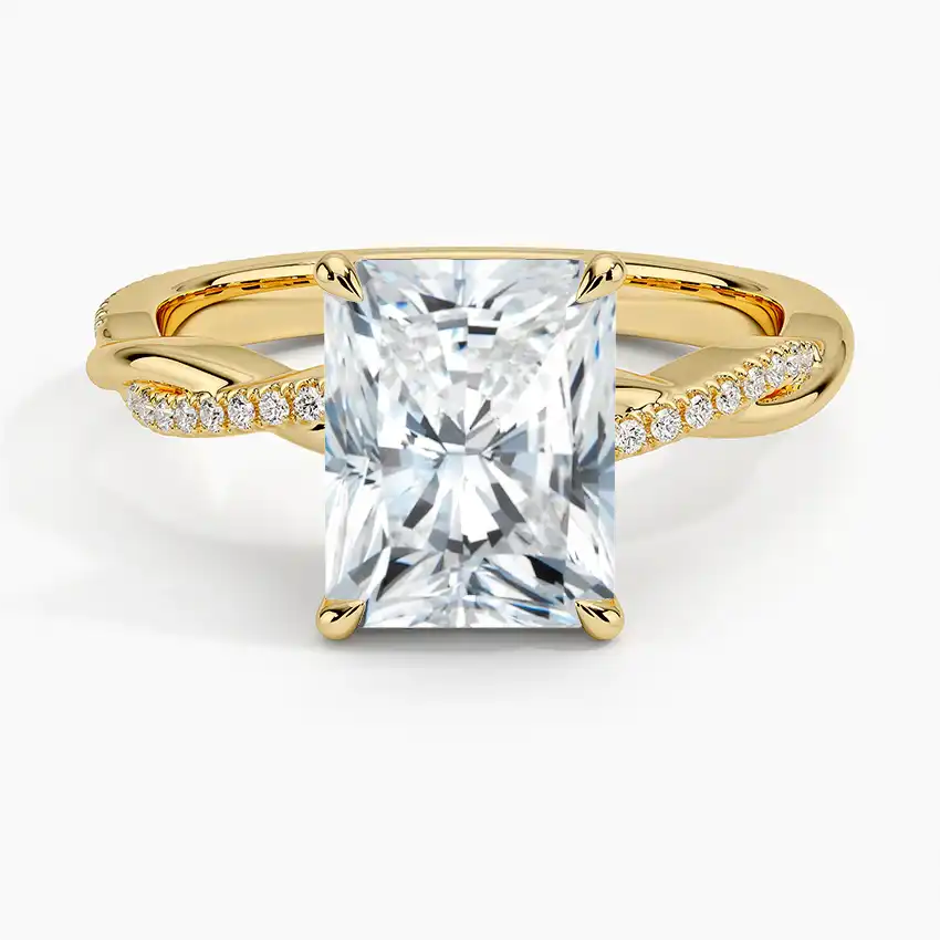 Radiant cut moissanite engagement ring with gold twisted band and pavé side stones