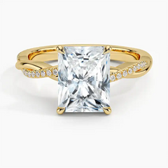 Radiant cut moissanite engagement ring with gold twisted band and pavé side stones