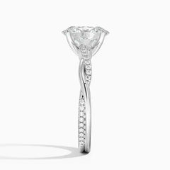 Moissanite engagement ring with twisted pavé band in white metal on white background