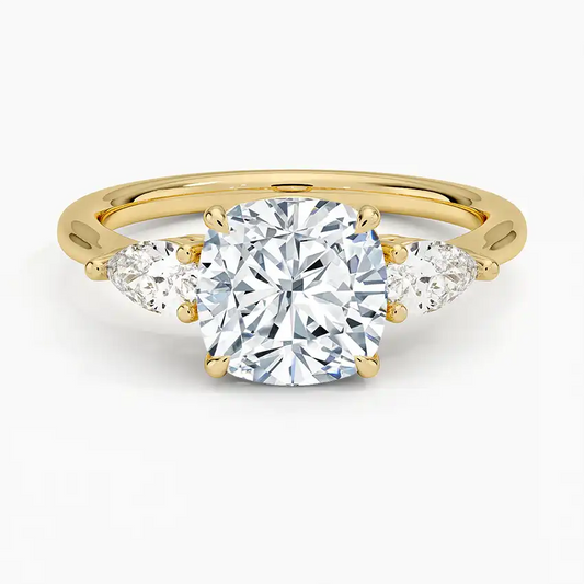 Gold moissanite engagement ring with cushion-cut center stone and two pear-shaped side stones