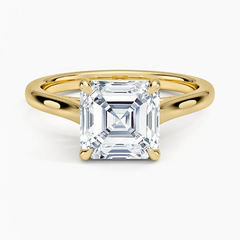 Asscher cut moissanite solitaire ring with yellow gold band on white background
