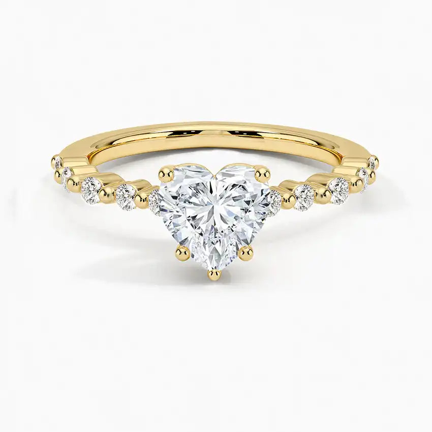 Heart-shaped moissanite engagement ring with gold band and diamond accents