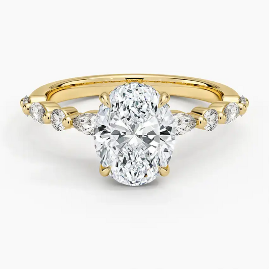 Oval moissanite engagement ring with side stones set on a yellow gold band