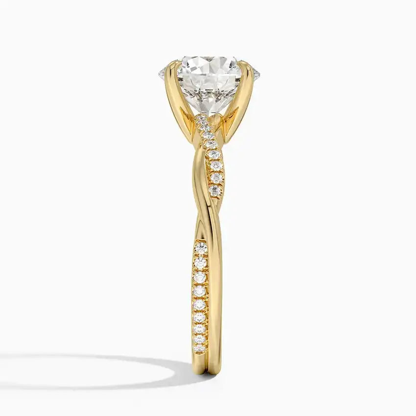 Gold moissanite solitaire engagement ring with pavé diamond accents and twisted band