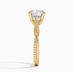 Gold moissanite solitaire engagement ring with pavé diamond accents and twisted band