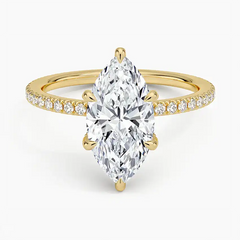 Marquise cut moissanite engagement ring with pavé diamond band in yellow gold setting