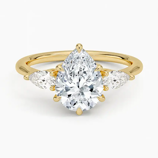 Gold band ring with pear-shaped moissanite center stone and side stones, luxury jewelry
