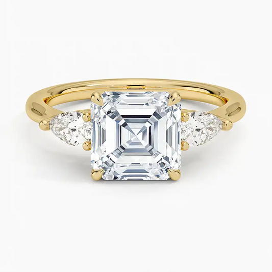 Asscher cut moissanite ring in yellow gold with pear side stones, elegant jewelry